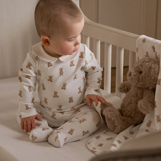 Baby in a crib with layette set